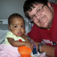 Then - This is Amyra when she was in the hospital way before the adoption was final. They had to take her a couple of times due to pneumonia stemming from her underdeveloped lungs due to being premature.