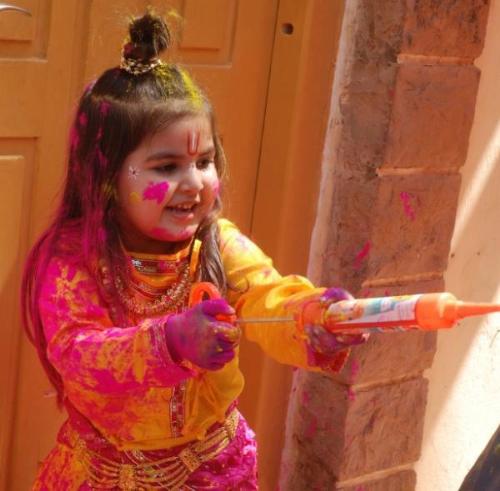 holi haiy - a girl throwing colored water