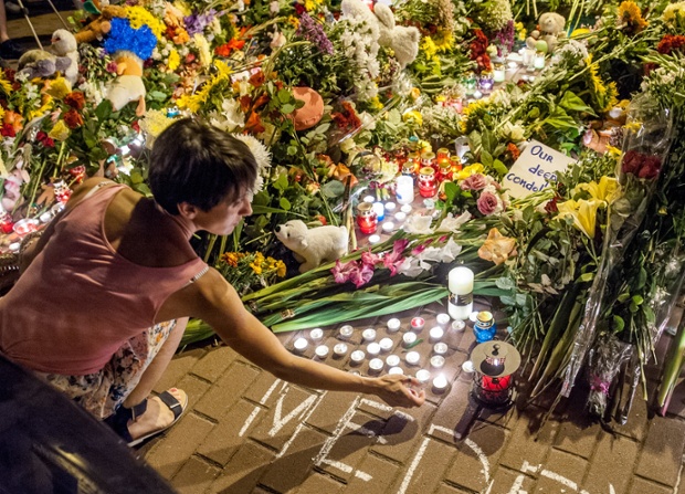 A woman lights a candle outside the Dutch embassy in Kiev. 173 nationals of the Netherlands were on board MH17