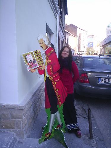 mozart - this is one of my best friends who wanted to have a photo with a big mozart add. it was in front of a chocolate shop. yummy