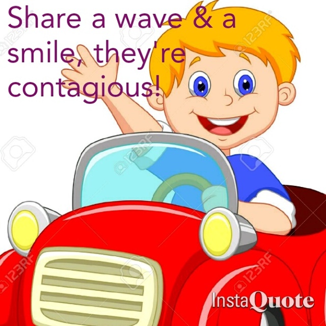 little boy in car smiling and waving