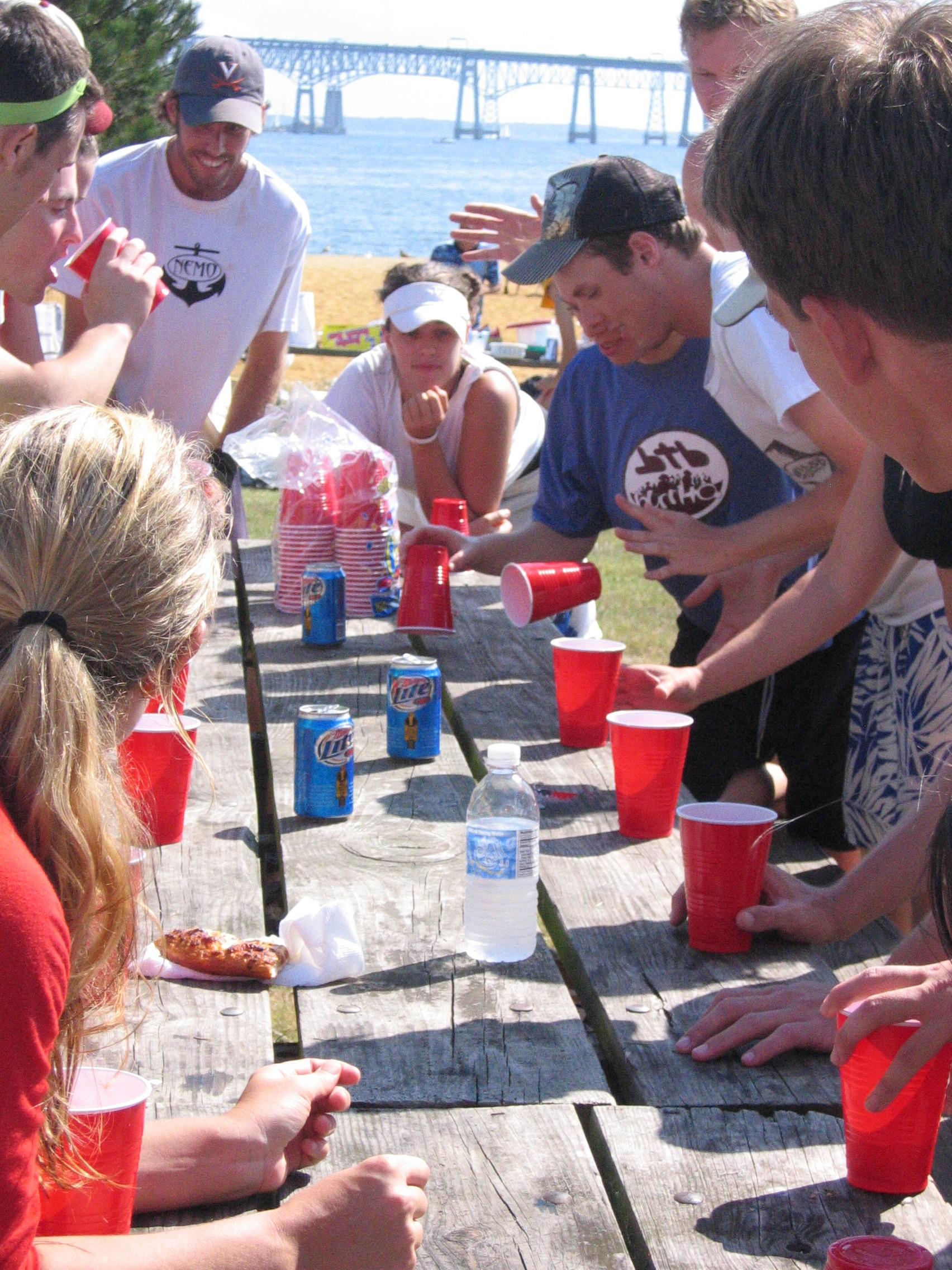 Flip cup game at cottage party