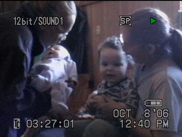family - my darling daugter bout to be held by her second oldest brother