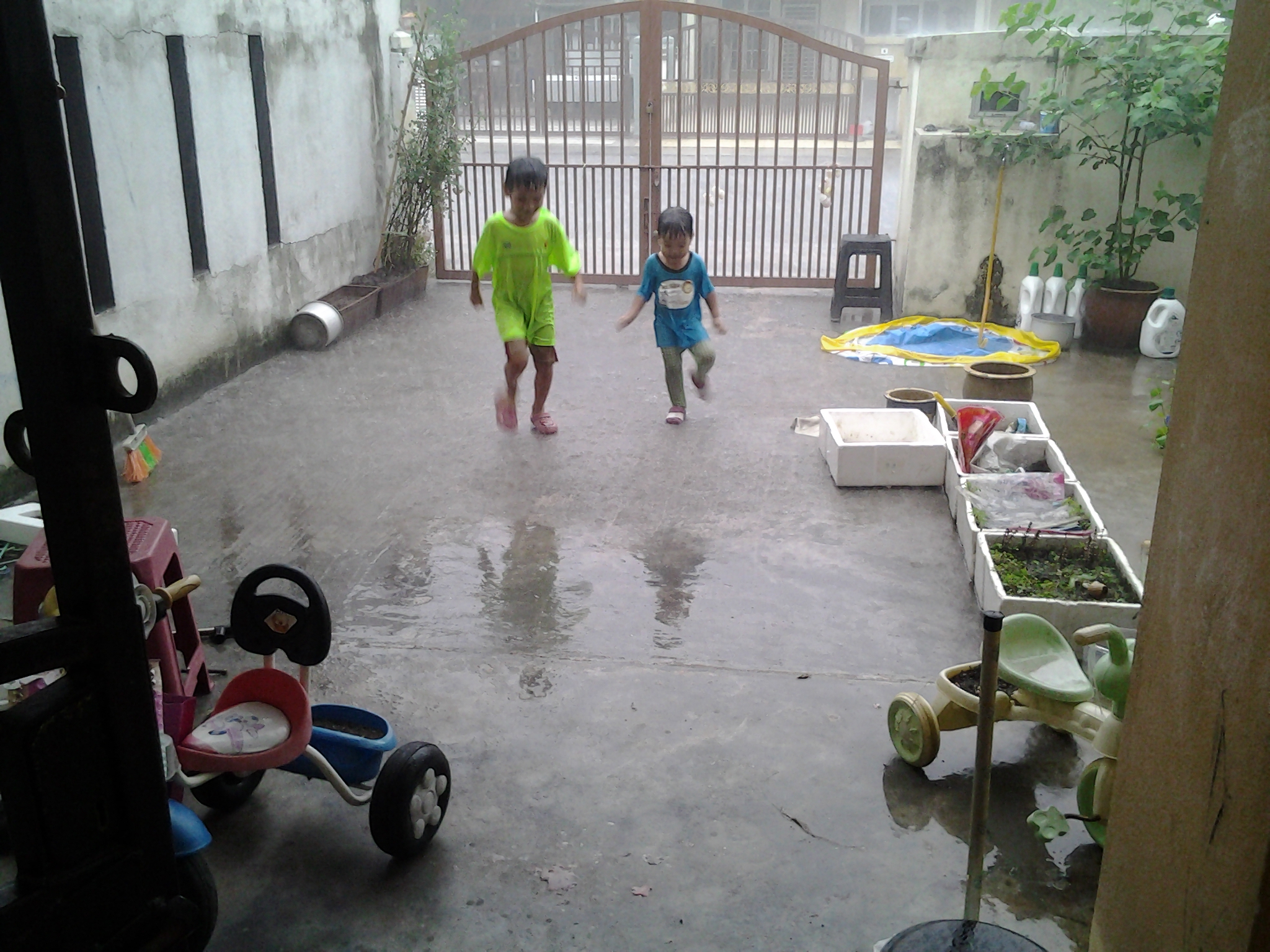 My children playing in the rain