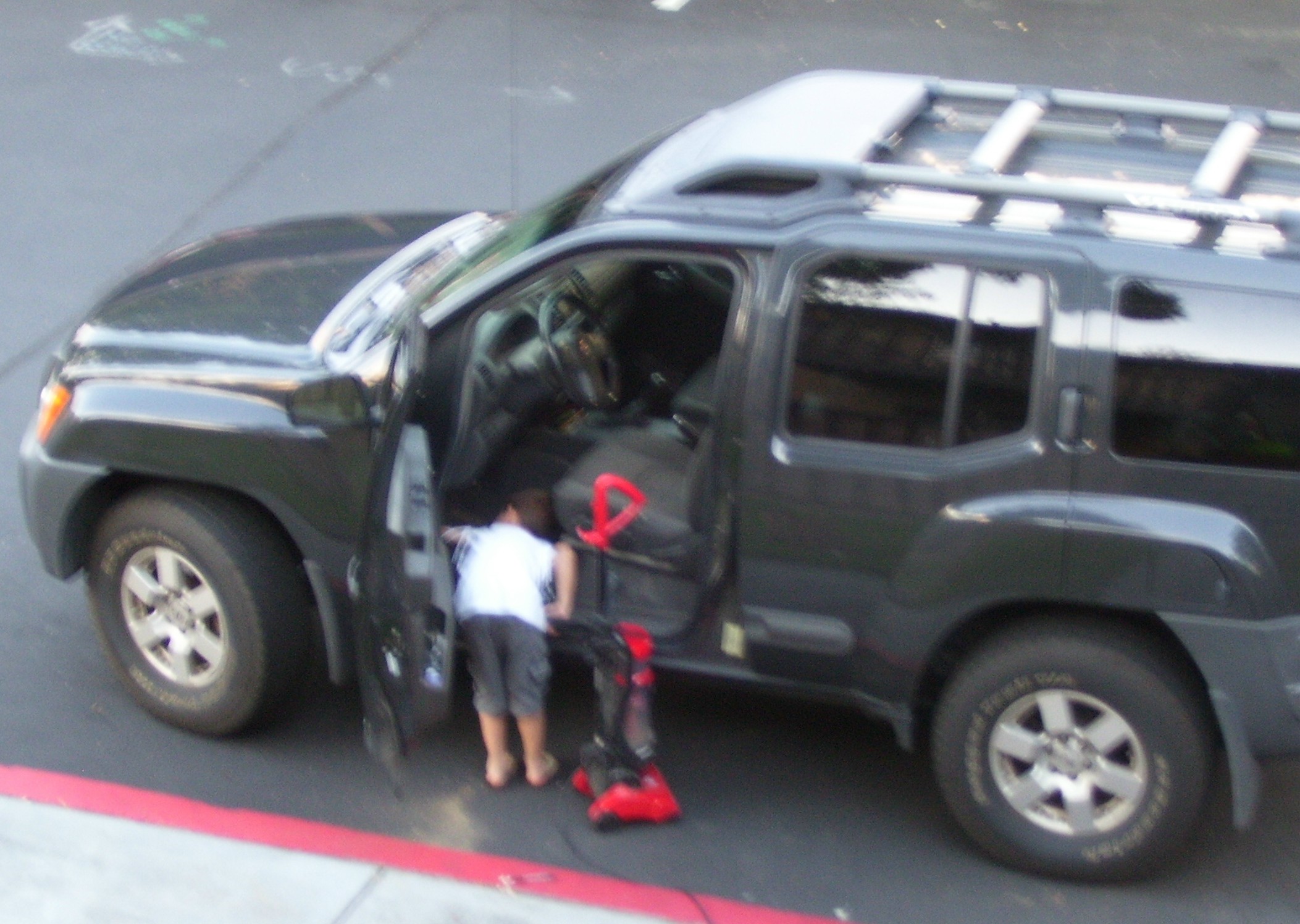 My young neighbor buddy helps me vacuum my SUV. My young neighbor buddy helps me vacuum my SUV.
