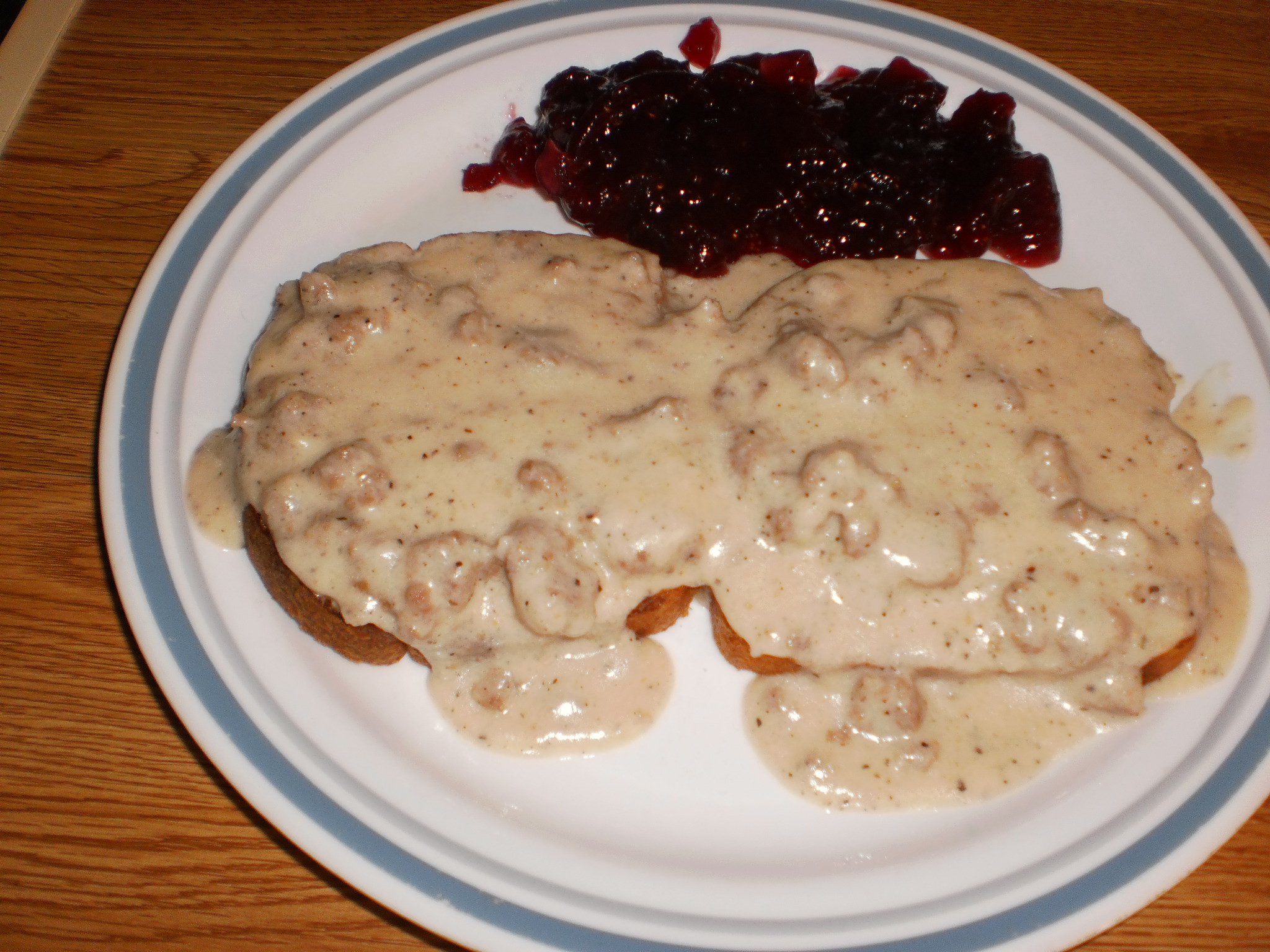 sausage gravy over toast with whole berry cranberry sauce 