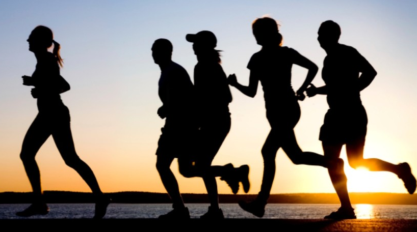 A profile of runners at sunset, free image