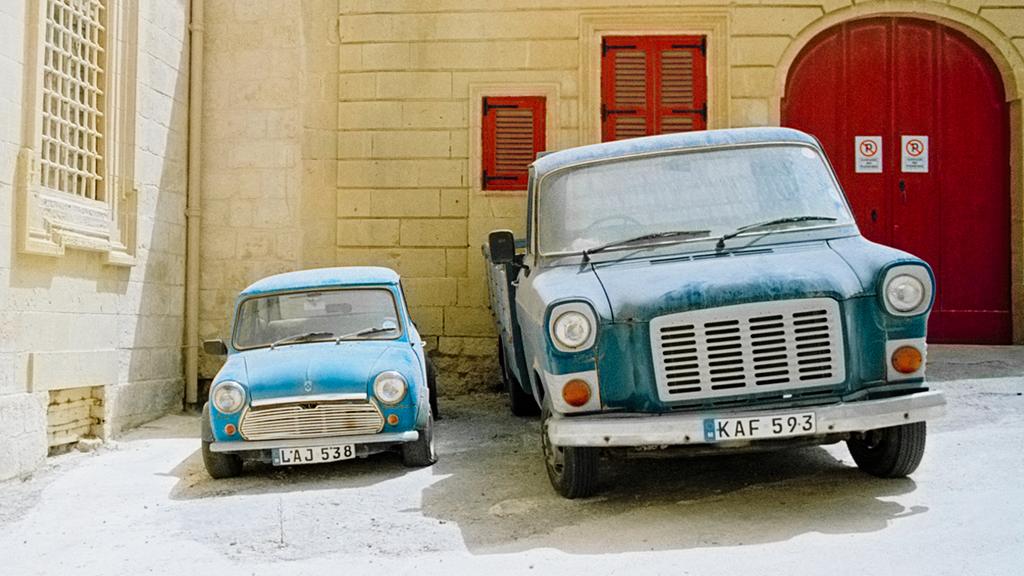 Vehicles parked-up outside a house in Malta