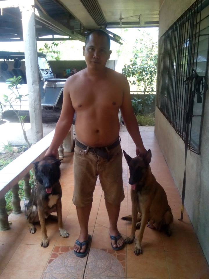 our Belgian Malinois (don&#039;t mind my hubby in the middle! lol)