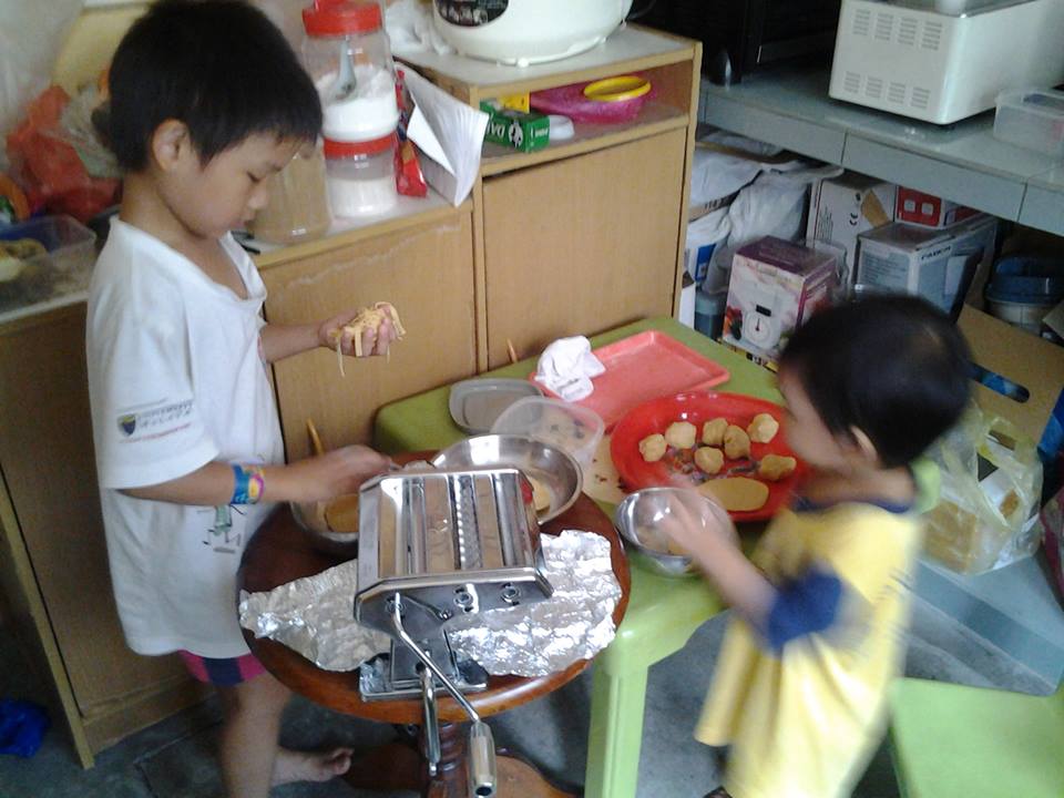 My children making noodles