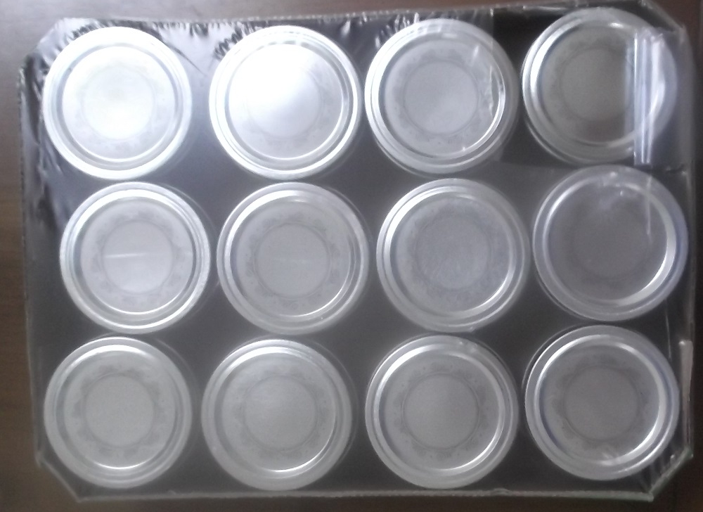 Photo I took of the box of jars that I bought for cross stitching on the lids.