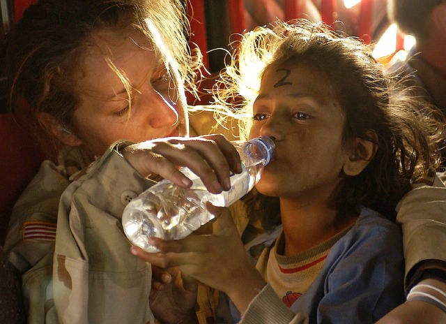Female US Soldier providing humanitarian aid. CC0 Public Domain Female US Soldier providing humanitarian aid. CC0 Public Domain