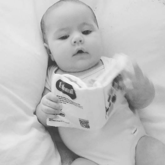 Emma, 4 months "reading" her book