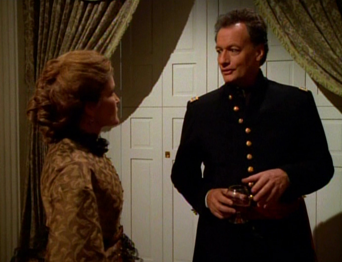 Capt. Kathryn Janeway (Kate Mulgrew) in Civil War garb with Q (John de Lancie)