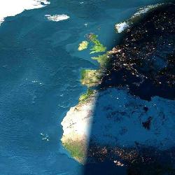 Day and Night - The photograph attached was taken by the crew on board the Columbia  during its last mission, on a cloudless day.  The picture is of Europe and Africa when the sun is setting.  Half of the picture is in night. The bright dots you see are the cities' lights.   The top part of Africa is the Sahara Desert .   Note that the lights are already on in Holland , Paris , and Barcelona , and that's it's still daylight in Dublin , London , Lisbon , and Madrid .   The sun is still shining on the Strait of Gibraltar . The Mediterranean Sea is already in darkness.   In the middle of the Atlantic Ocean you can see the Azores Islands;  below them to the right are the Madeira Islands ; a bit below are the  Canary Islands; and further South, close to the farthest western point  of Africa , are the Cape Verde Islands.   Note that the Sahara is huge and can be seen clearly both during  day time and night time.   To the left, on top, is Greenland , totally frozen .  Who'll have a chance to see all this?? We are lucky!!