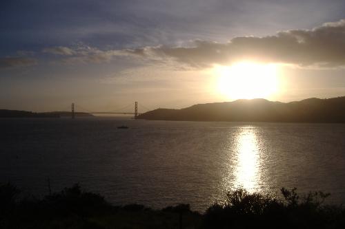 Bay sunset - I took this picture looking west from Angel Island in San Francisco Bay. We were on Angel Island doing log outs as storm damage clearance. Viewable is the Golden Gate bridge and the the beginings of Marin county. I used to want to be a photographer, this one was one of my favorites.
