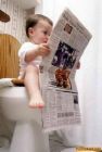 Throne - Young child sitting on the toilet reading a newspaper.