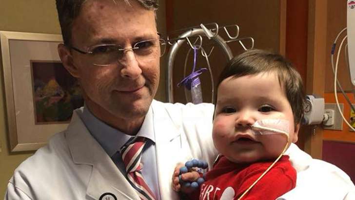 Doctor Dean McKenzie with a patient in a children's hospital in Atlanta Doctor Dean McKenzie with a patient in a children's hospital in Atlanta