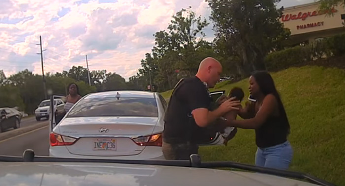 Officer Jeremie Nix taking care of a child that needed help 