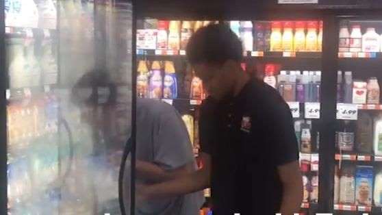 A good deed by a young man to assist an employee stock the shelves A good deed by a young man to assist an employee stock the shelves