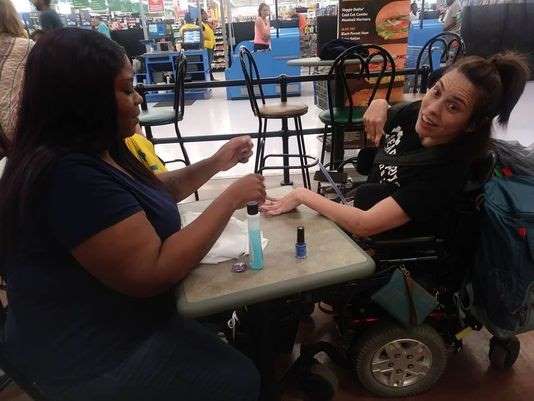 Wal Mart cashier Ebony Harris at work with a customer in Michigan