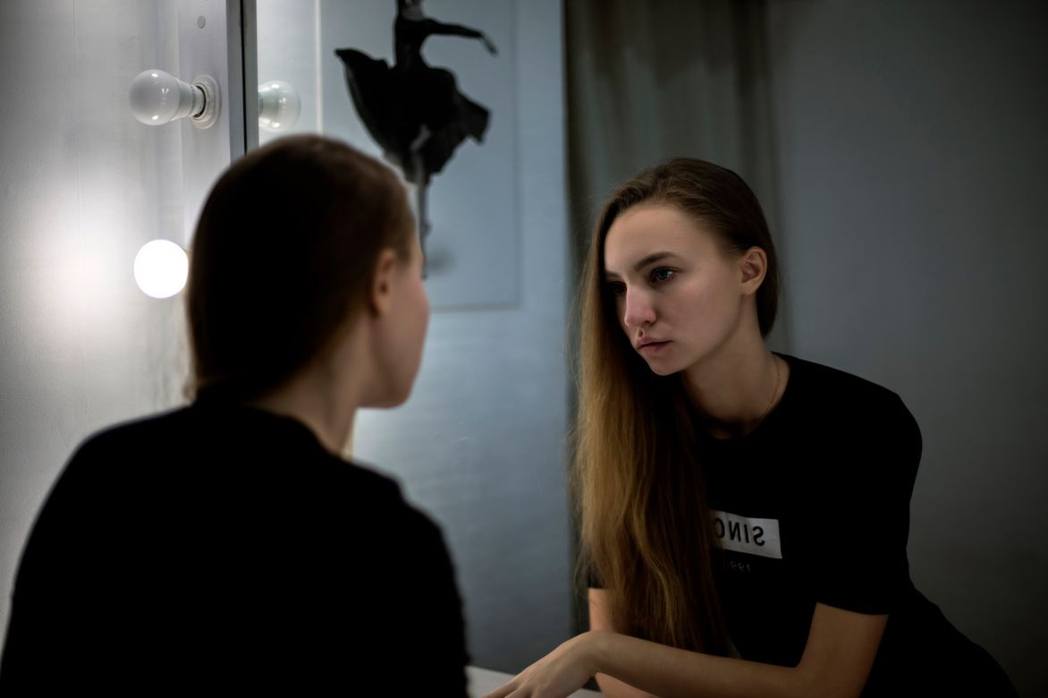 Girl looking into the mirror