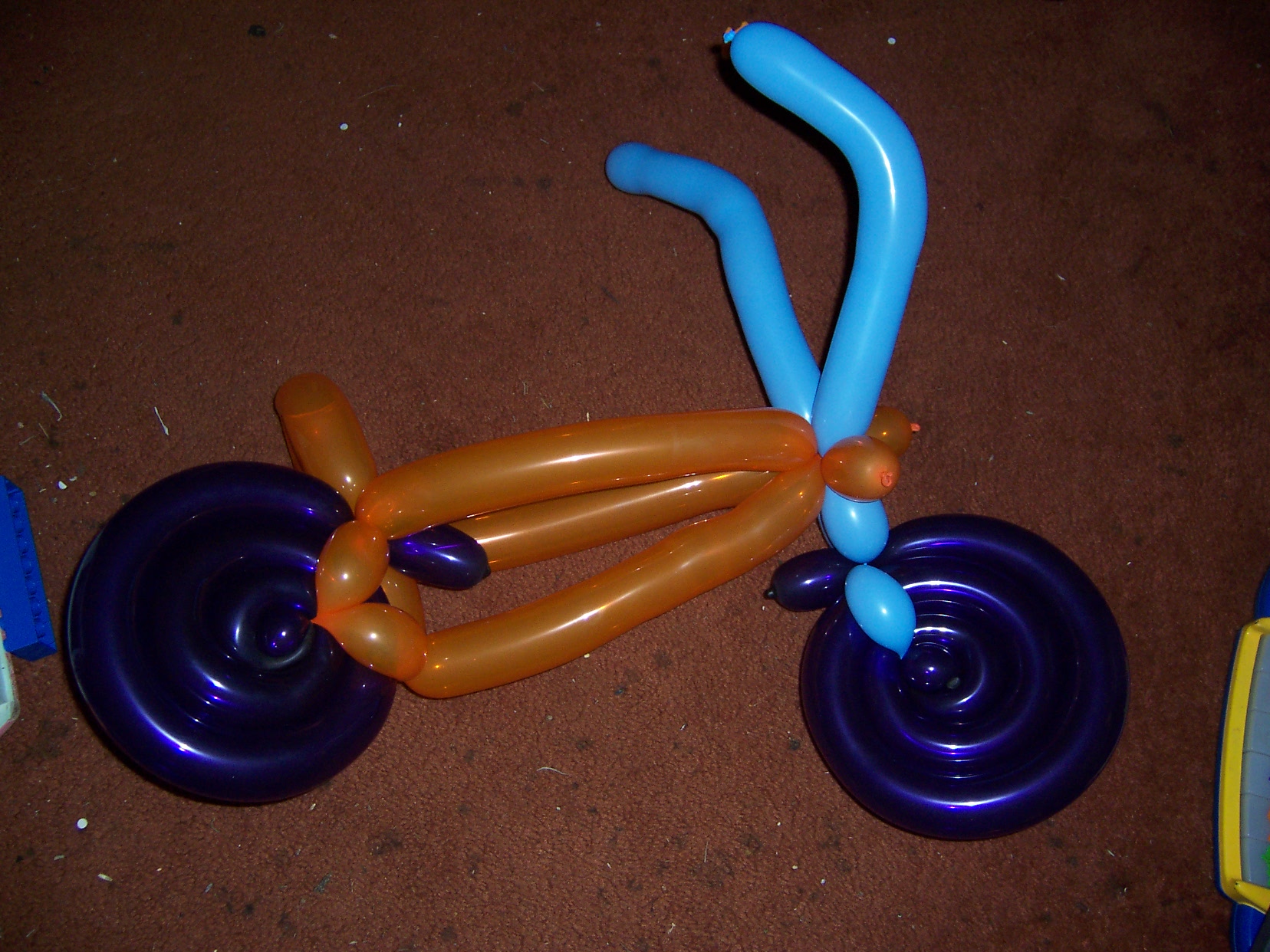Cool Balloon Creations - 1 - There is a clown in town who works at kids nights at restaurants and she makes such cool things that when we got home one night we took pictures of it.  Observe, a balloon motorcyle!