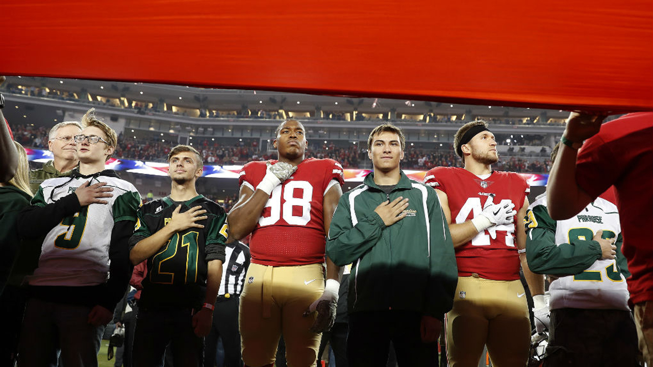 San Francisco 49ers football team with the Paradise High School footballers San Francisco 49ers football team with the Paradise High School footballers