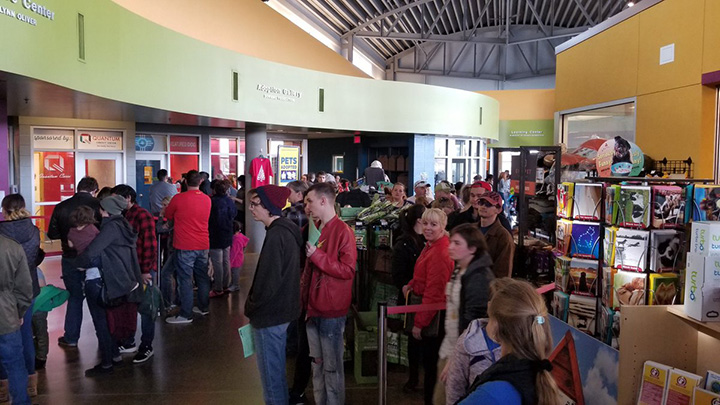 Families are in line to adopt dogs, cats and mammals at a animal shelter. Families are in line to adopt dogs, cats and mammals at a animal shelter.