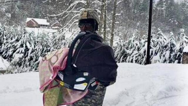 National Guard soldier doing his duty to help a family leave the home
