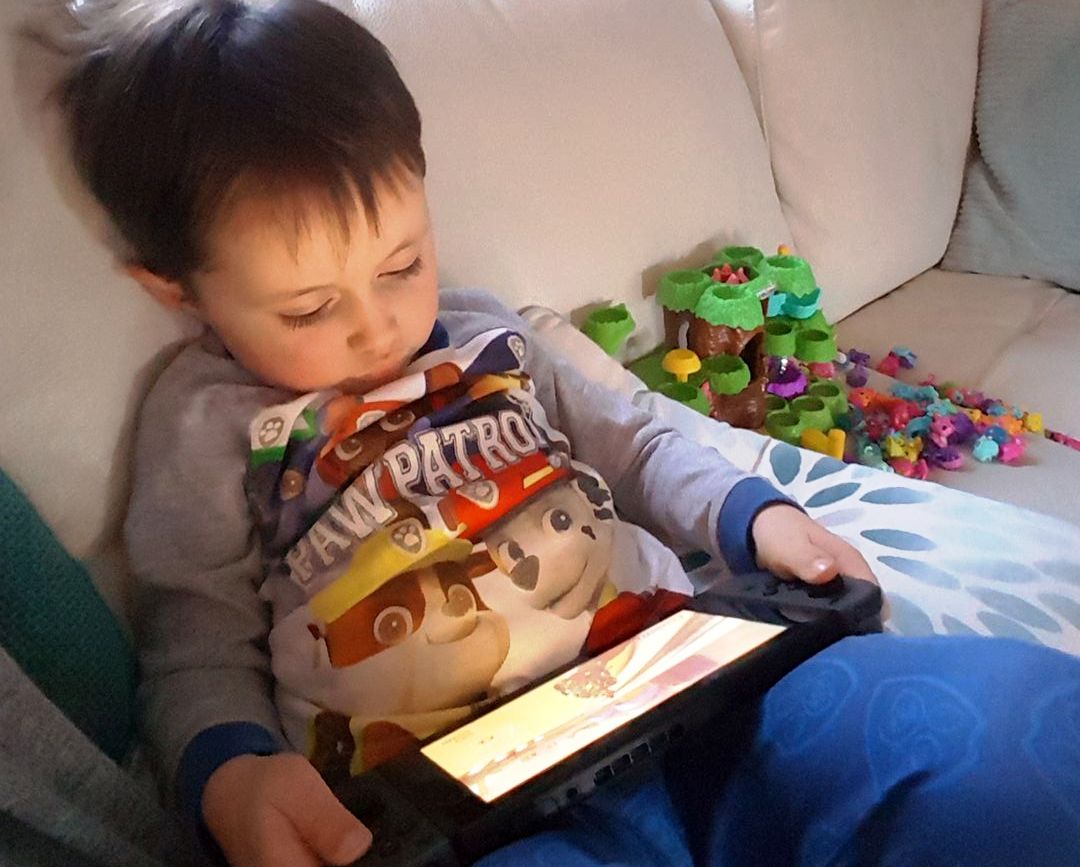Our grandson and his iPad (my own photo)