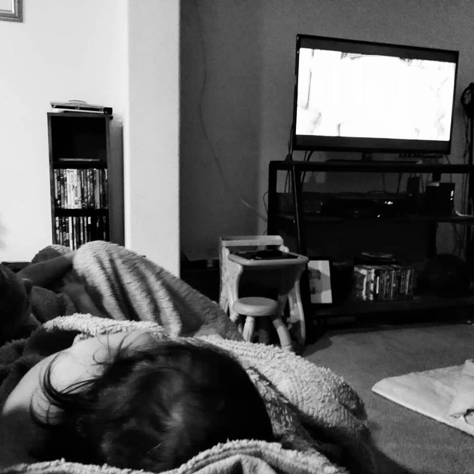 Black and white of my girls sleeping on my lap watching movies