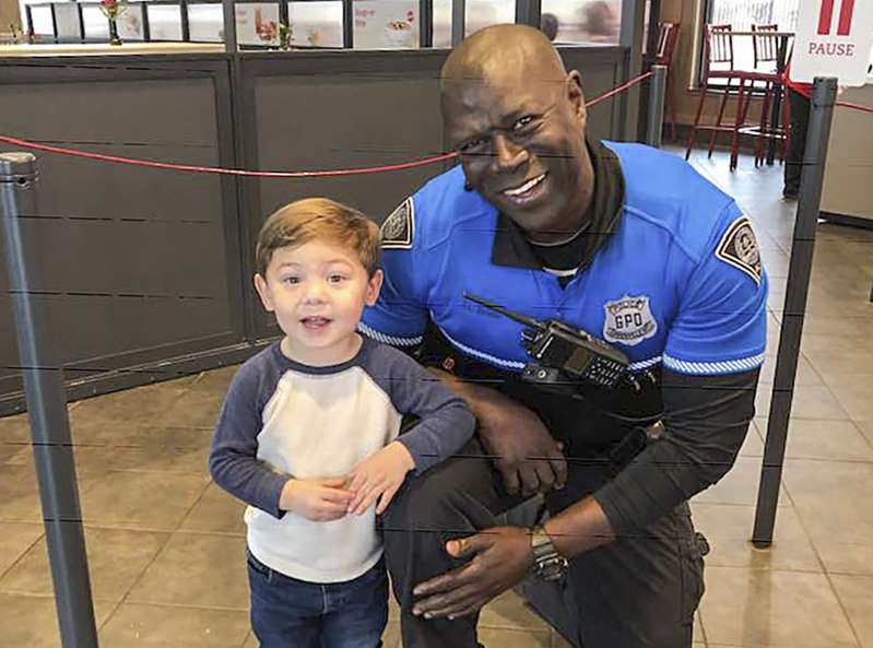 Young boy and Greenville police officer Terence Brister Young boy and Greenville police officer Terence Brister