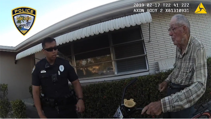 Two Cape Coral Police officer present a new bike for an elderly man Two Cape Coral Police officer present a new bike for an elderly man