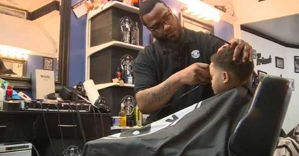 Nick Baynes cutting the hair of a customer in West End Ohio Nick Baynes cutting the hair of a customer in West End Ohio