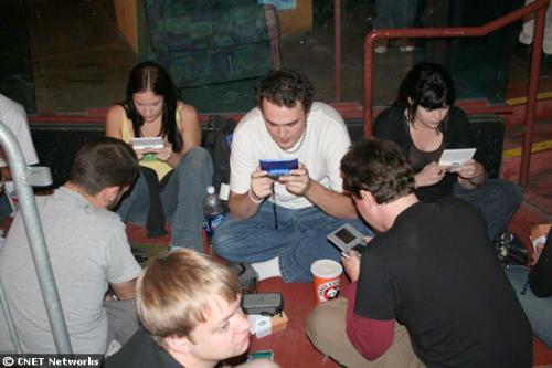 playing at Los Angeles - Several groups of friends kept busy while waiting in line to get their Wii by playing Mario Kart against each other wirelessly on their portable Nintendo DS game consoles.