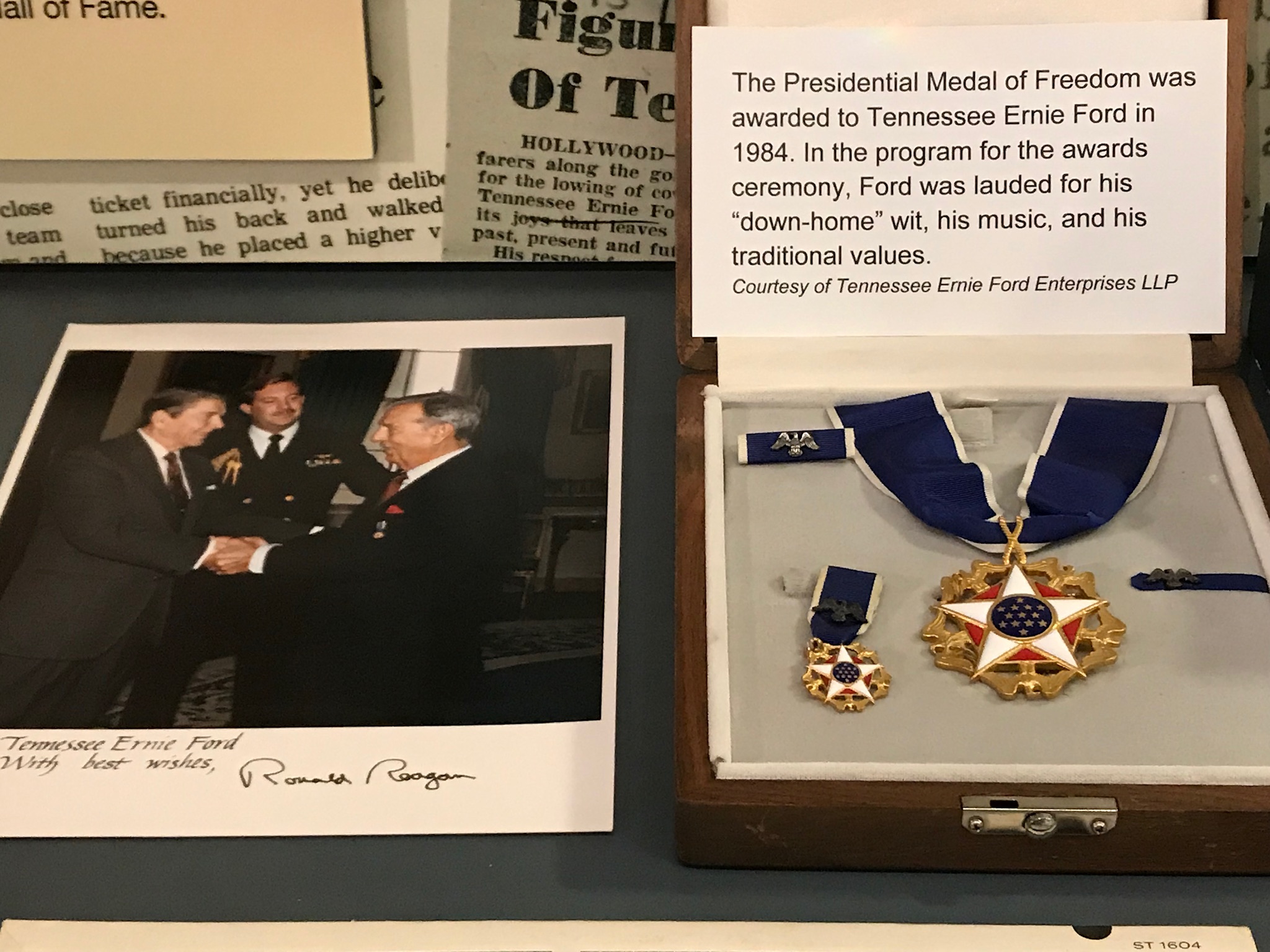Tennessee Ernie’s Presidential Medal of Freedom, along with a photo of President Reagan presenting it. Photo taken by and the property of FourWalls. Tennessee Ernie’s Presidential Medal of Freedom, along with a photo of President Reagan presenting it. Photo taken by and the property of FourWalls.