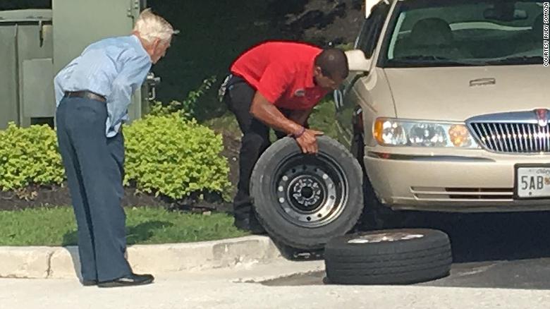 Mister Lee watching Daryl Howard fix a flat tire on his auto in Maryland Mister Lee watching Daryl Howard fix a flat tire on his auto in Maryland