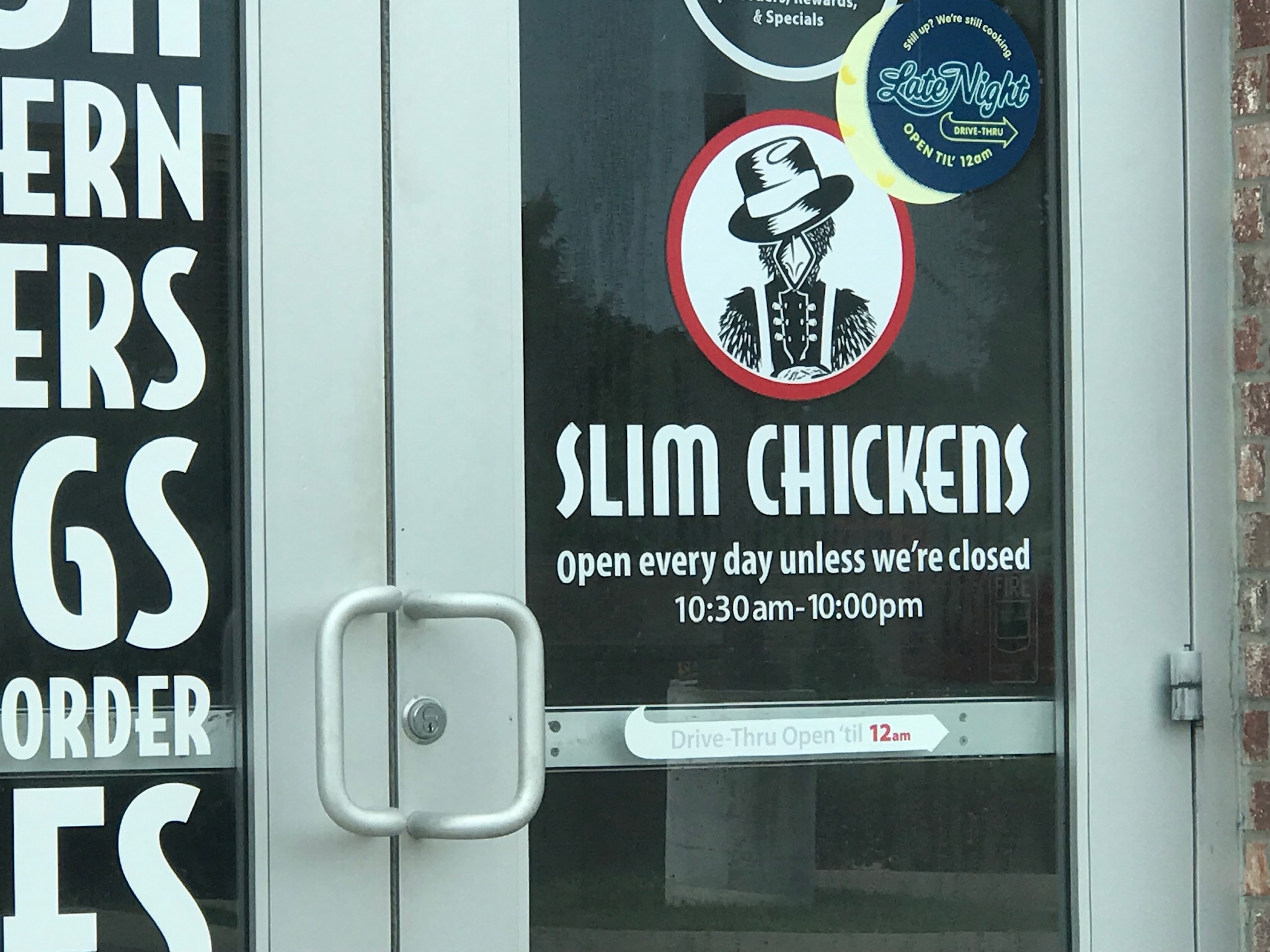 The funny sign on the entrance to Slim Chickens in Murfreesboro, Tennessee. Photo taken by and the property of FourWalls. The funny sign on the entrance to Slim Chickens in Murfreesboro, Tennessee. Photo taken by and the property of FourWalls.
