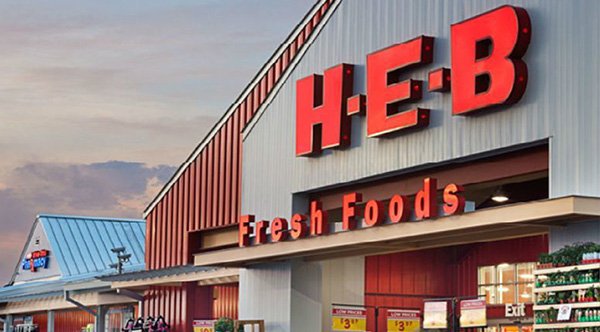 A straneger at a checkout line at a H E B Store pays for a grocery bill A straneger at a checkout line at a H E B Store pays for a grocery bill