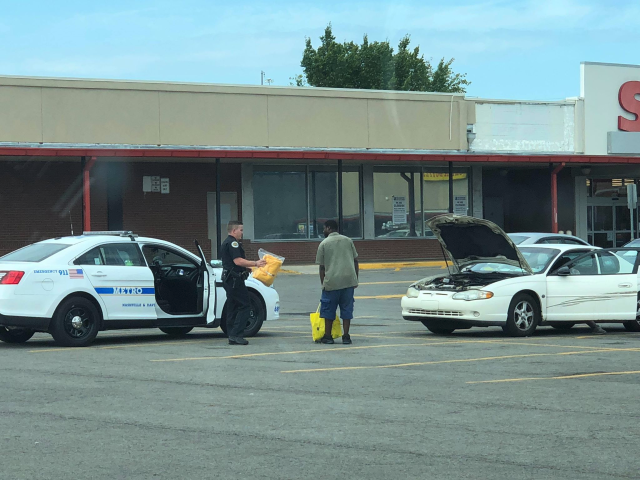 A Nashville police officer assists a needy couple get their needs met