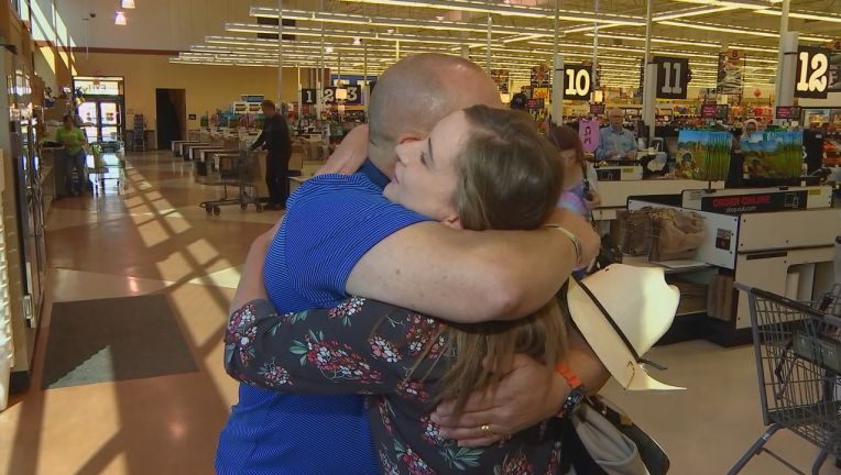 Peter Bergeron hugs Mandy at a food store in Minnesota 