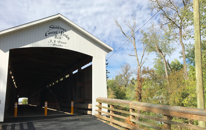 The Shieldstown bridge, with some foliage along the banks of the White River, in Indiana.  Photo taken by and the property of FourWalls.