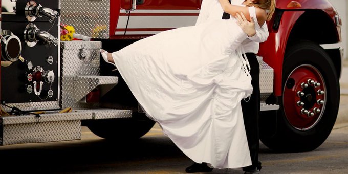 A bride to be arrives to her wedding via the firetruck route. A bride to be arrives to her wedding via the firetruck route.