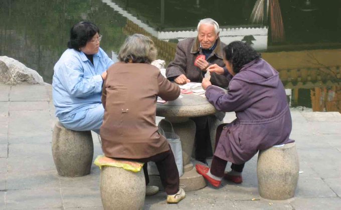 A group of senior citizens playing board games A group of senior citizens playing board games