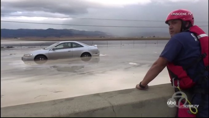 A California Highway Patrol officer to the rescue of a driver in a flood A California Highway Patrol officer to the rescue of a driver in a flood