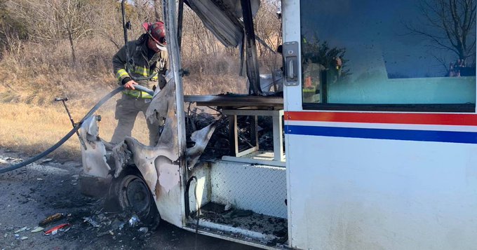 A Kansas firefighter putting out a fire on a USPS delivery truck in Kansas A Kansas firefighter putting out a fire on a USPS delivery truck in Kansas