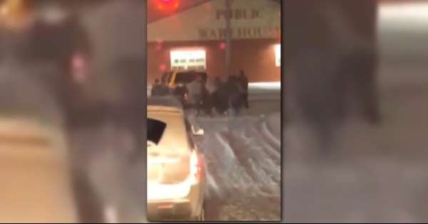 High school wrestler using teamwork to get a car out of the snow High school wrestler using teamwork to get a car out of the snow