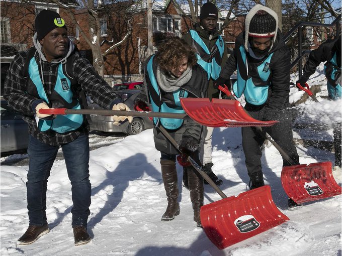 Immigrants from other nations using shovels to get of snow in Canada Immigrants from other nations using shovels to get of snow in Canada