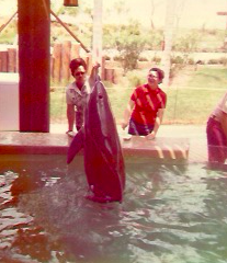 My mother (left) and me, enjoying feeding the dolphins at Marineland in Florida in the mid-1970s.  Photo taken by my dad.